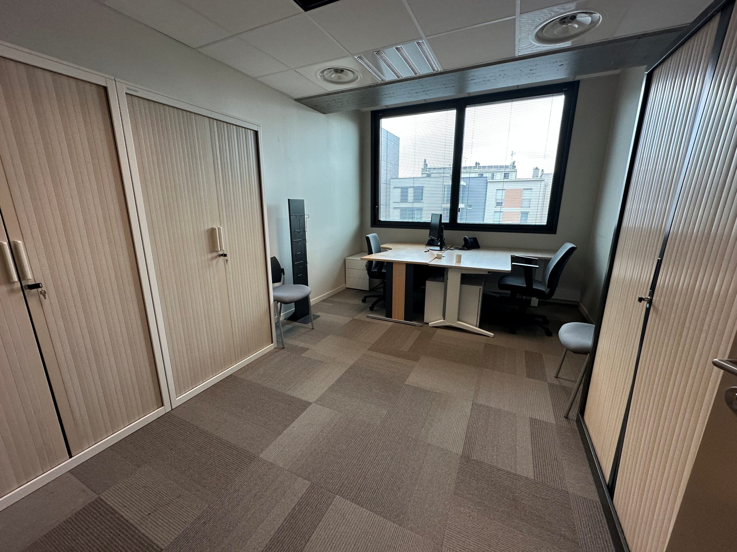 Office with two desks, chairs, and large cabinets.